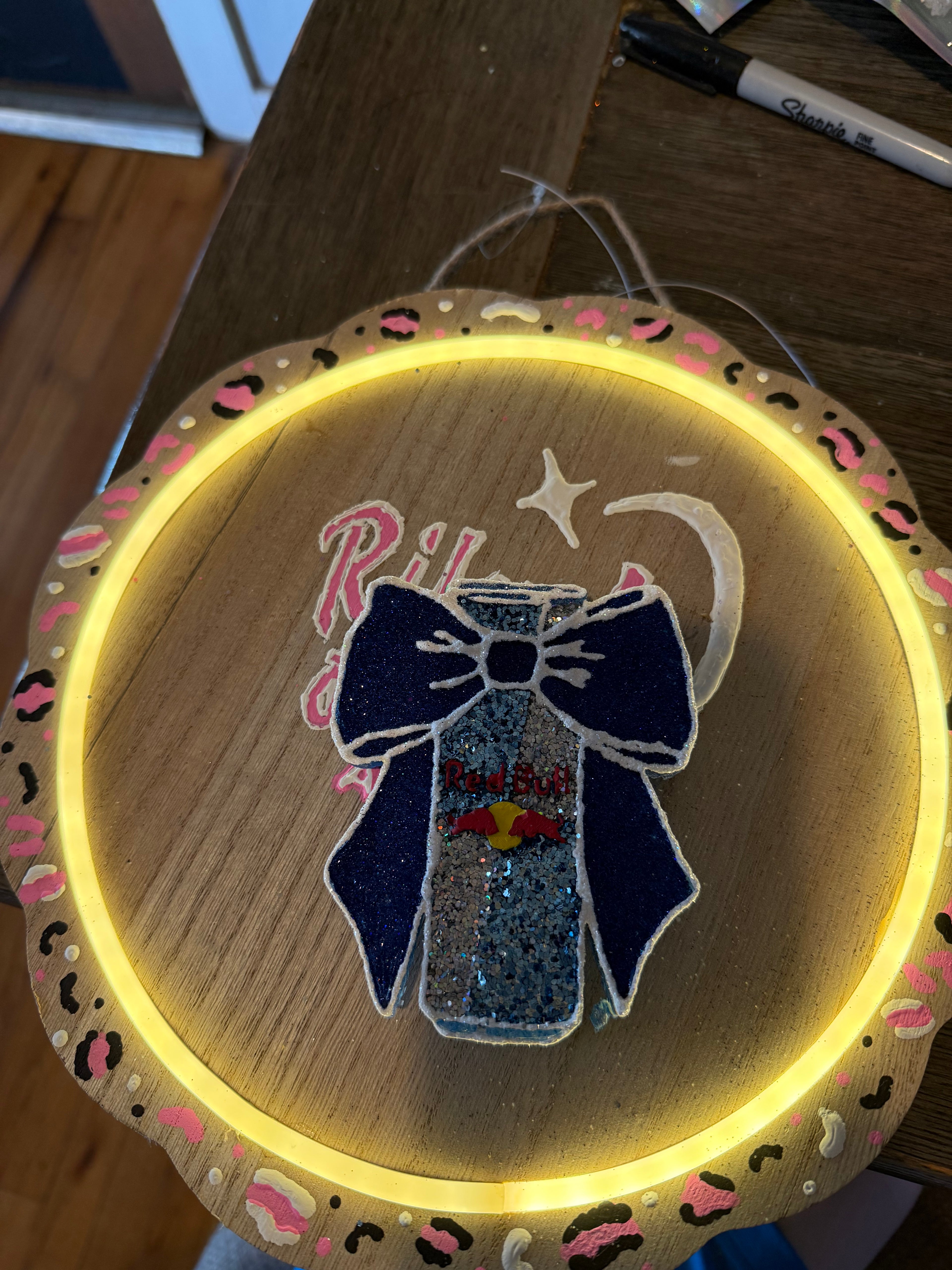 Decorative hoop with a bow design on a wooden surface