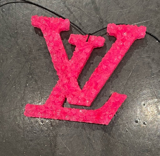 Pink bubble wrap with a logo on a dark surface