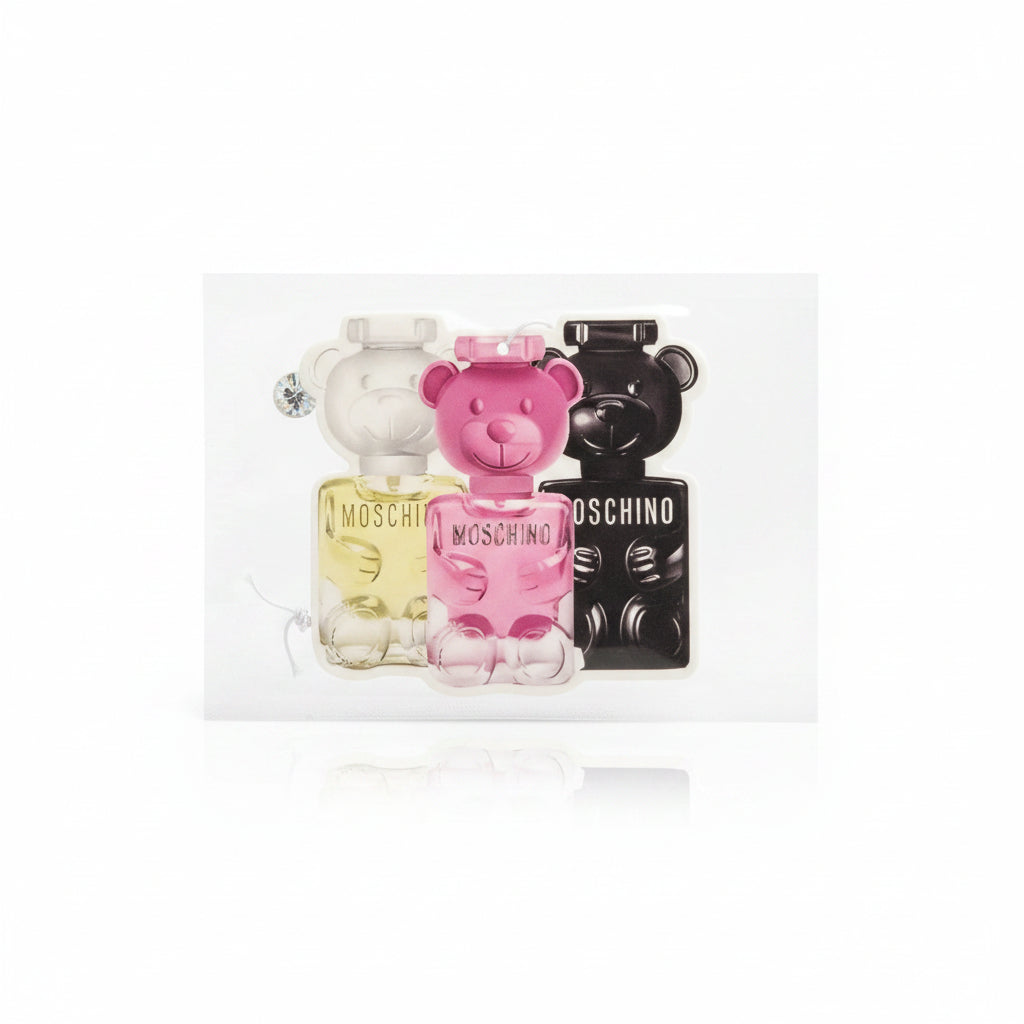 Moschino perfume bottles in packaging on a wooden floor